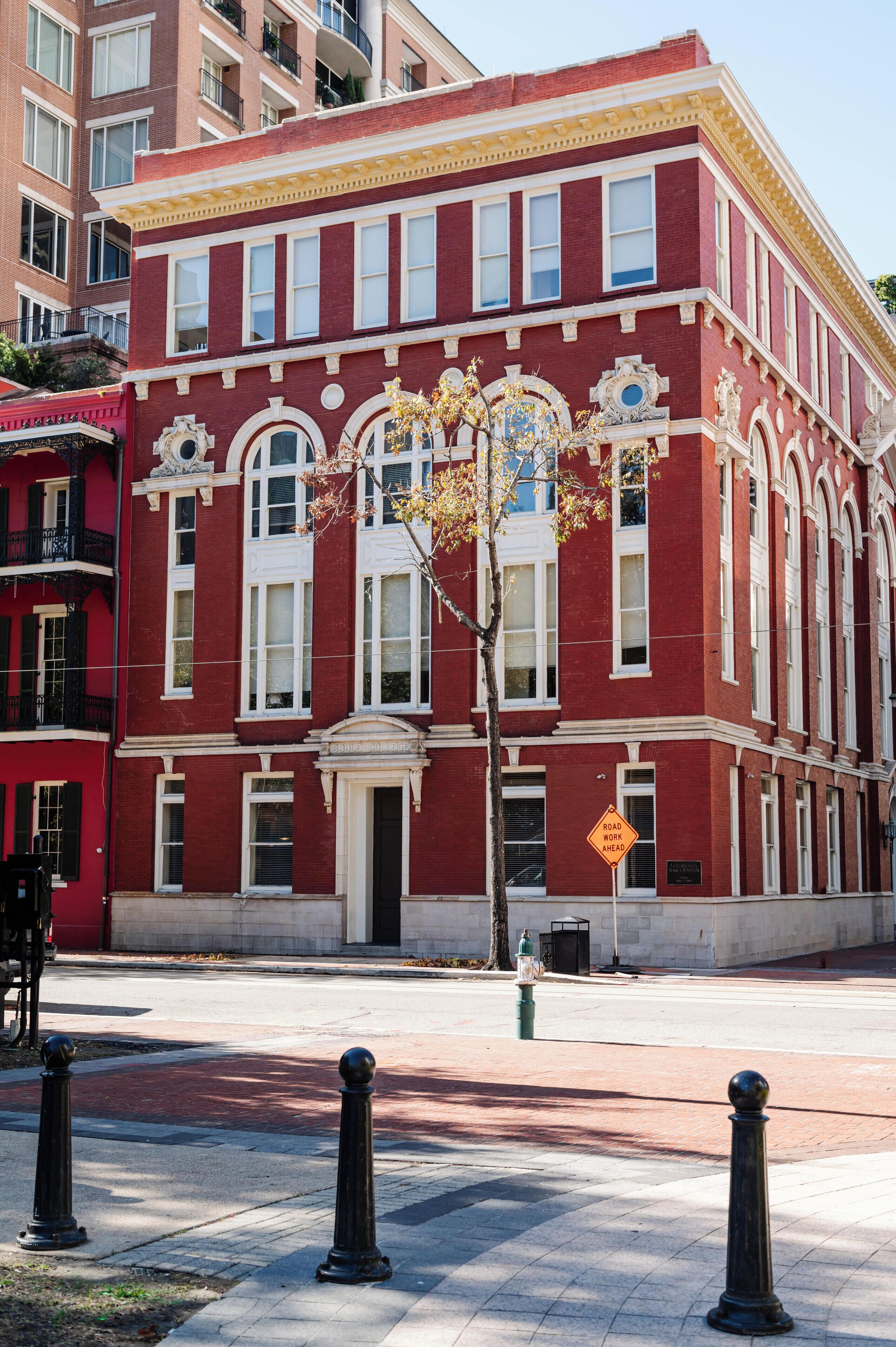 A red brick building with white trim and large windows.