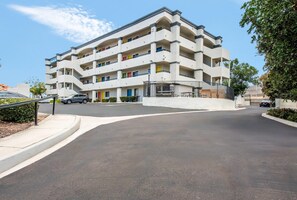 A multi-story residential building with balconies, a gated entrance, and a parking area. - Rodeway Inn San Diego South San Ysidro Border (San Ysidro)