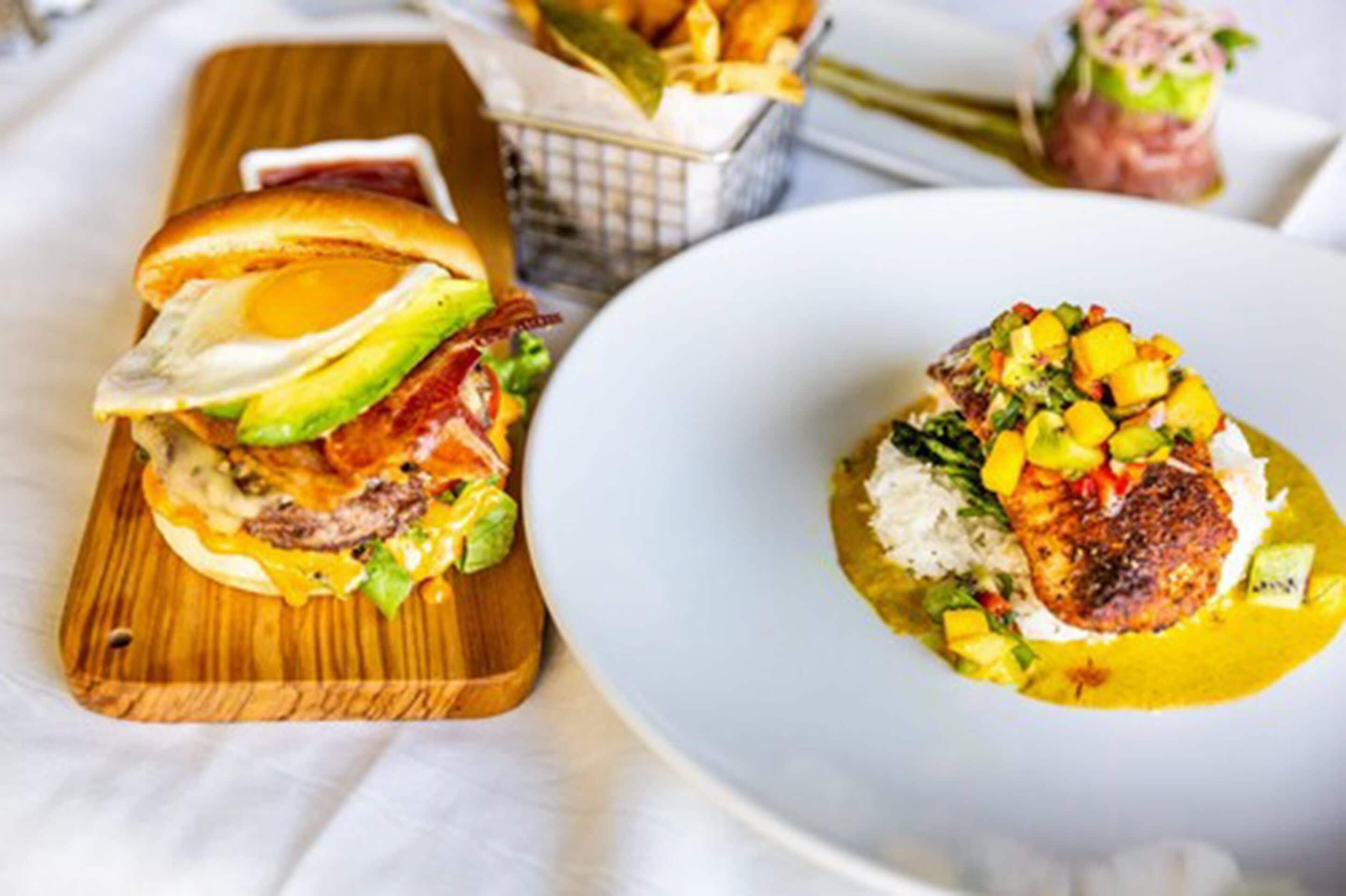 A meal with a burger and a plate of food.