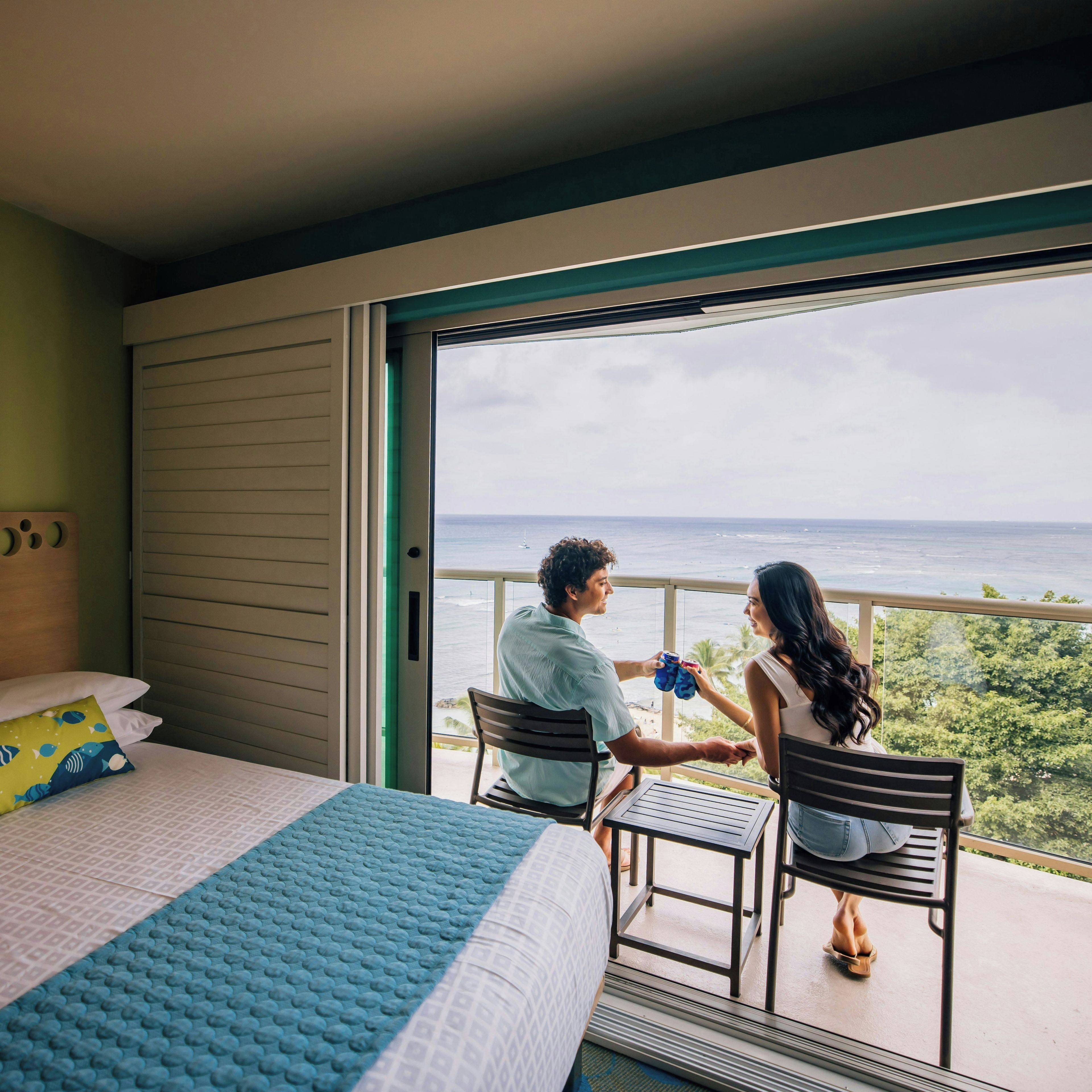 A bedroom with a bed, a window, and a balcony.