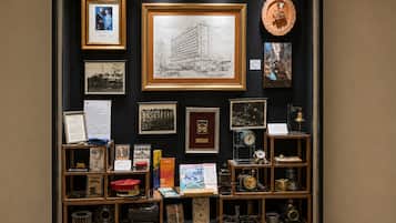 A display case with various historical photographs, documents, and mechanical objects.