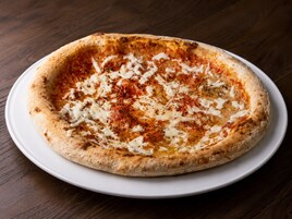 A pizza on a white plate.