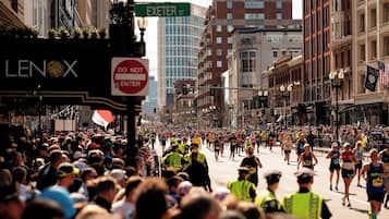 A busy street scene with runners, a 'DO NOT ENTER' sign, and a Lenox sign.