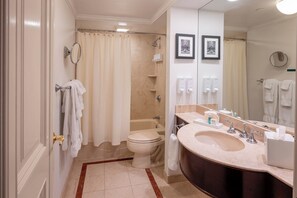 A bathroom with a toilet, shower, sink, and a large mirror. - The Lenox Hotel Boston (Boston)