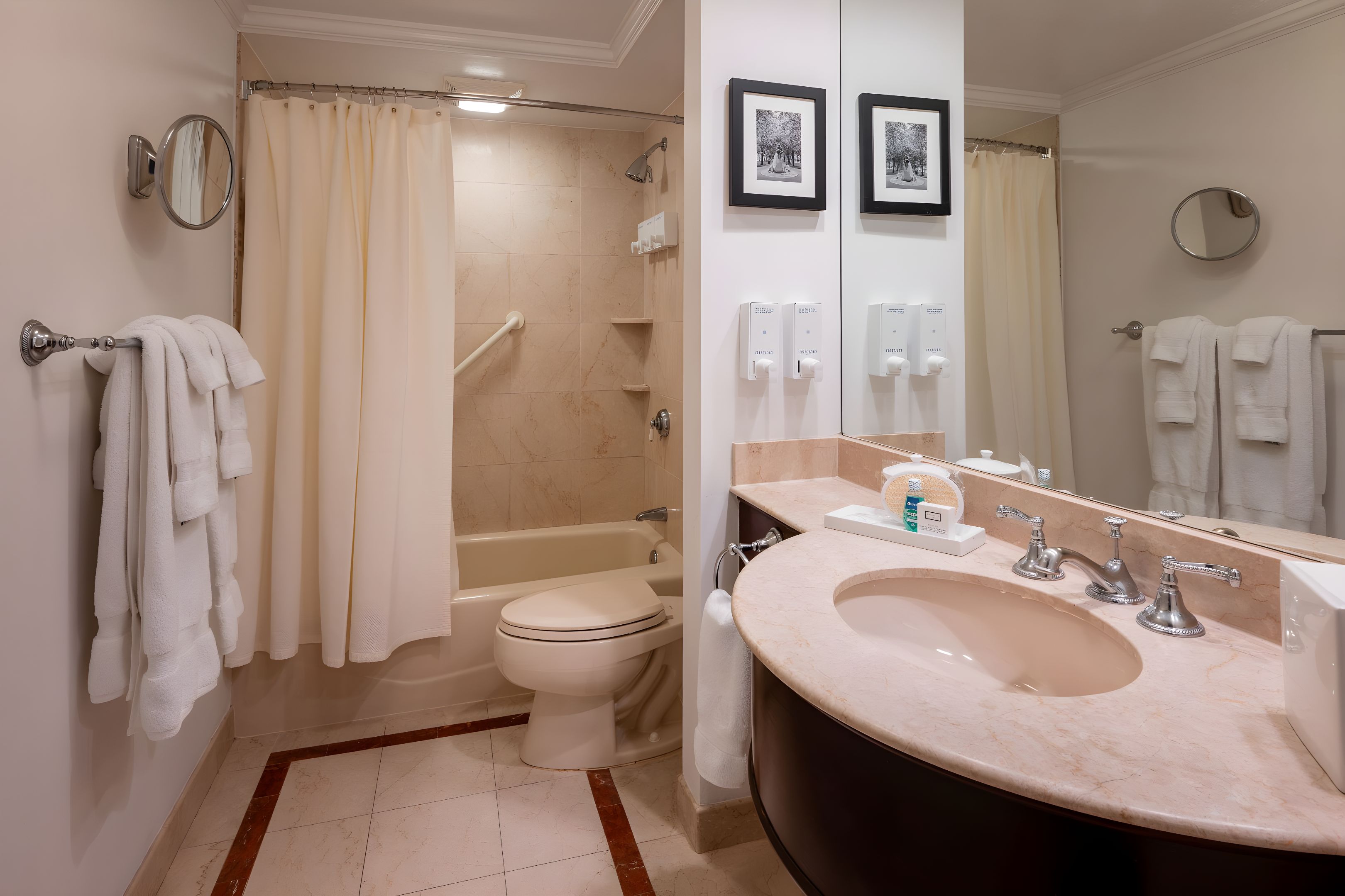 A bathroom with a bathtub, toilet, and sink.