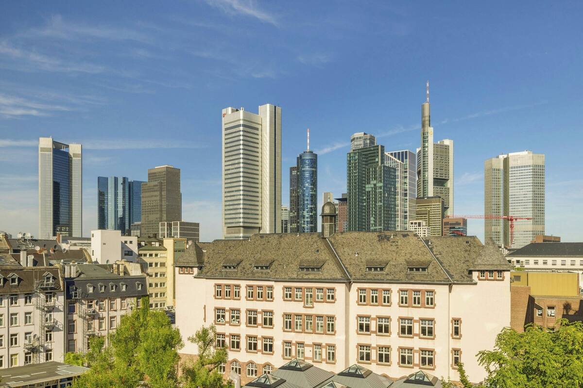 A cityscape with modern high-rise buildings and older, traditional architecture.