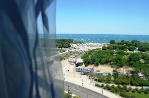 A coastal cityscape with a clear view of the sea, a bridge, and a parking area. - Congress Plaza Hotel (Chicago)