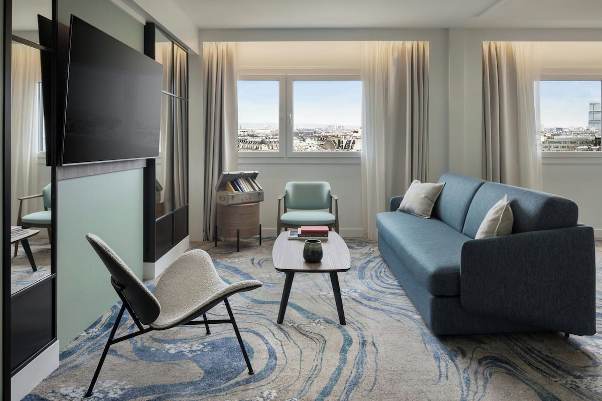 Executive Suite, 2 Bedrooms, City View | Living room | 55-inch flat-screen TV with cable channels, TV, books