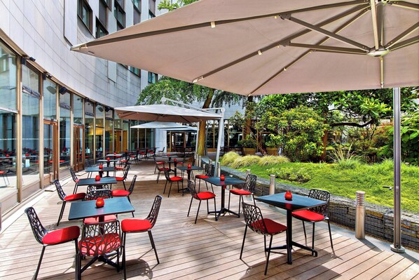Enjoy meals in a serene garden setting with comfortable seating and shade.