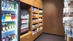 A hotel pantry with shelves stocked with snacks, beverages, and condiments. - Dubuque Inn & Suites (Dubuque)
