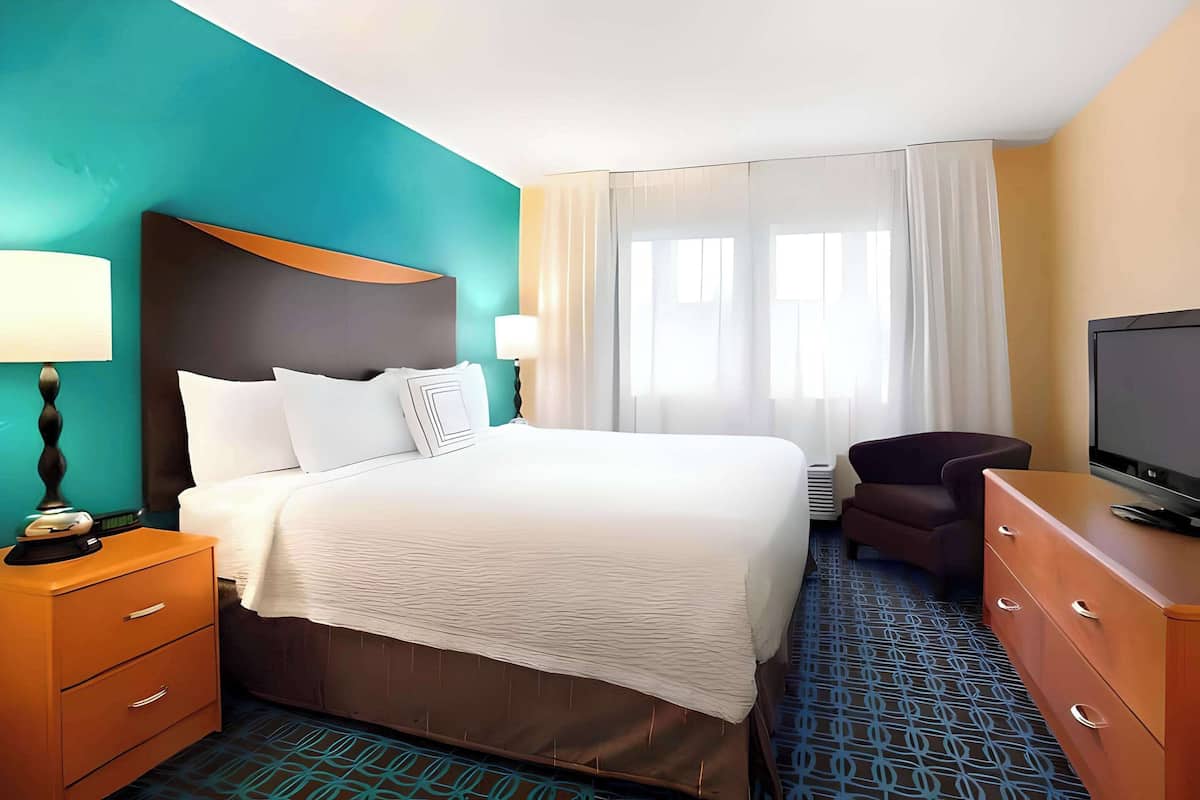 premium bedding, desk, blackout curtains, iron/ironing board