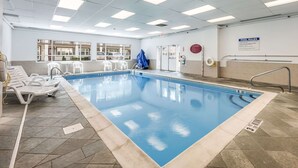 An indoor swimming pool with clear pool rules, a lifeguard chair, and a poolside area with lounge chairs. - Quality Inn Poughkeepsie (Poughkeepsie)