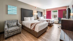 A hotel room with two beds, a desk, a chair, and a TV. - Quality Inn Poughkeepsie (Poughkeepsie)