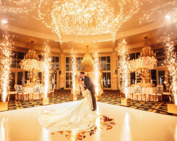 A grand ballroom with a white floor and ornate chandeliers, surrounded by tables set for a wedding reception. - Trump National Doral Miami (Miami)