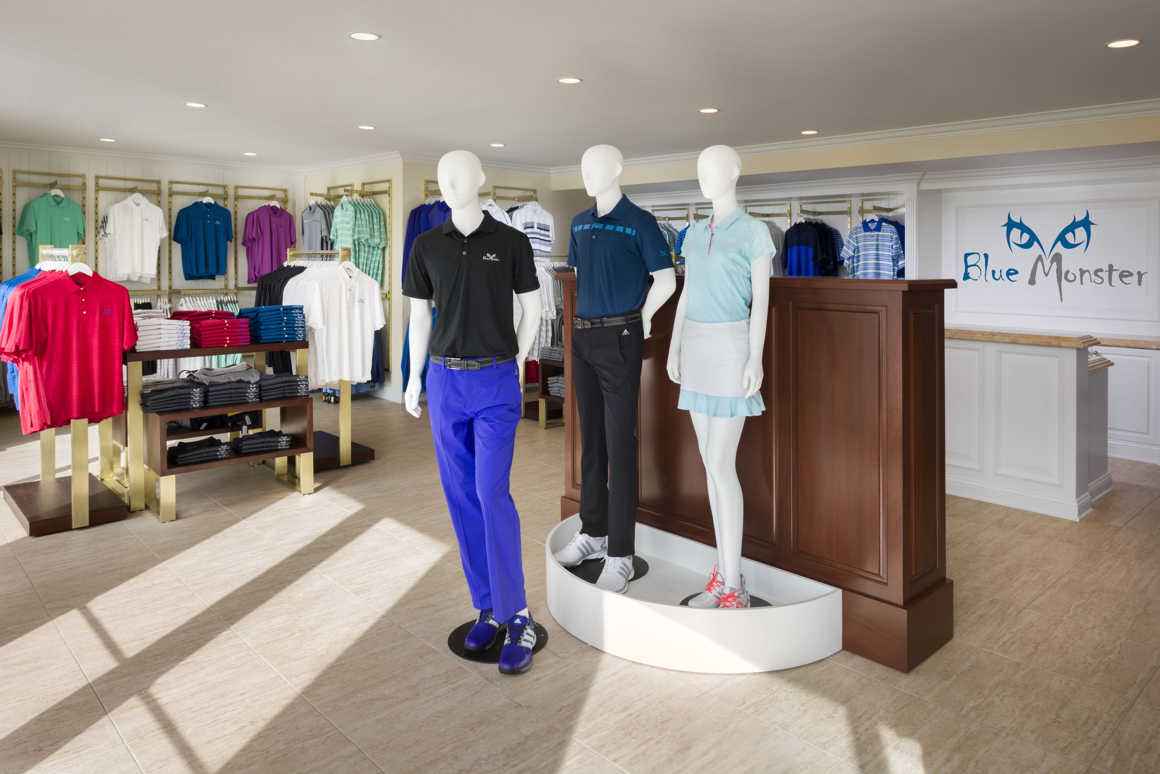A clothing store with mannequins displaying various outfits.