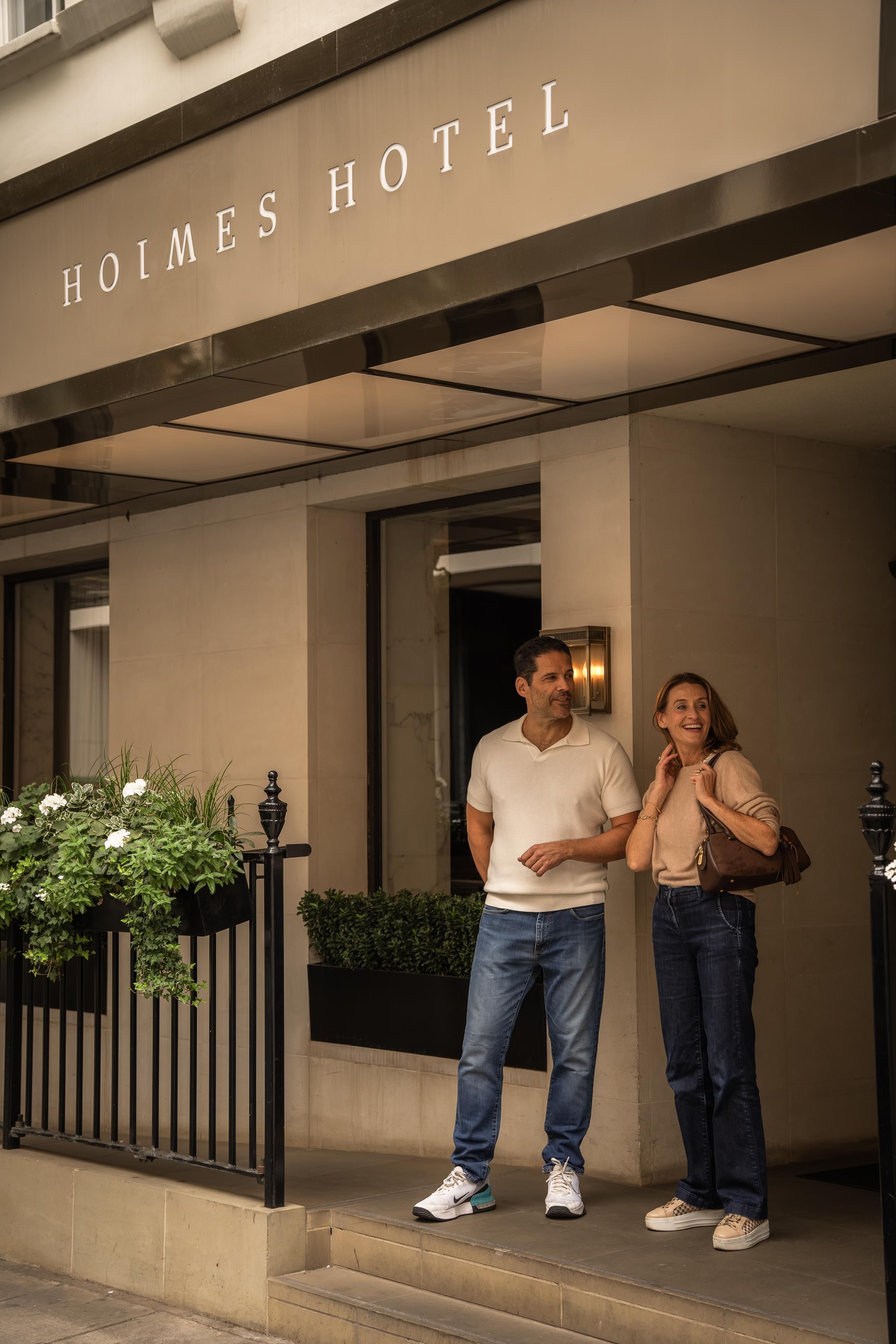 A hotel entrance with a sign reading 'HOIMES HOTEL'.