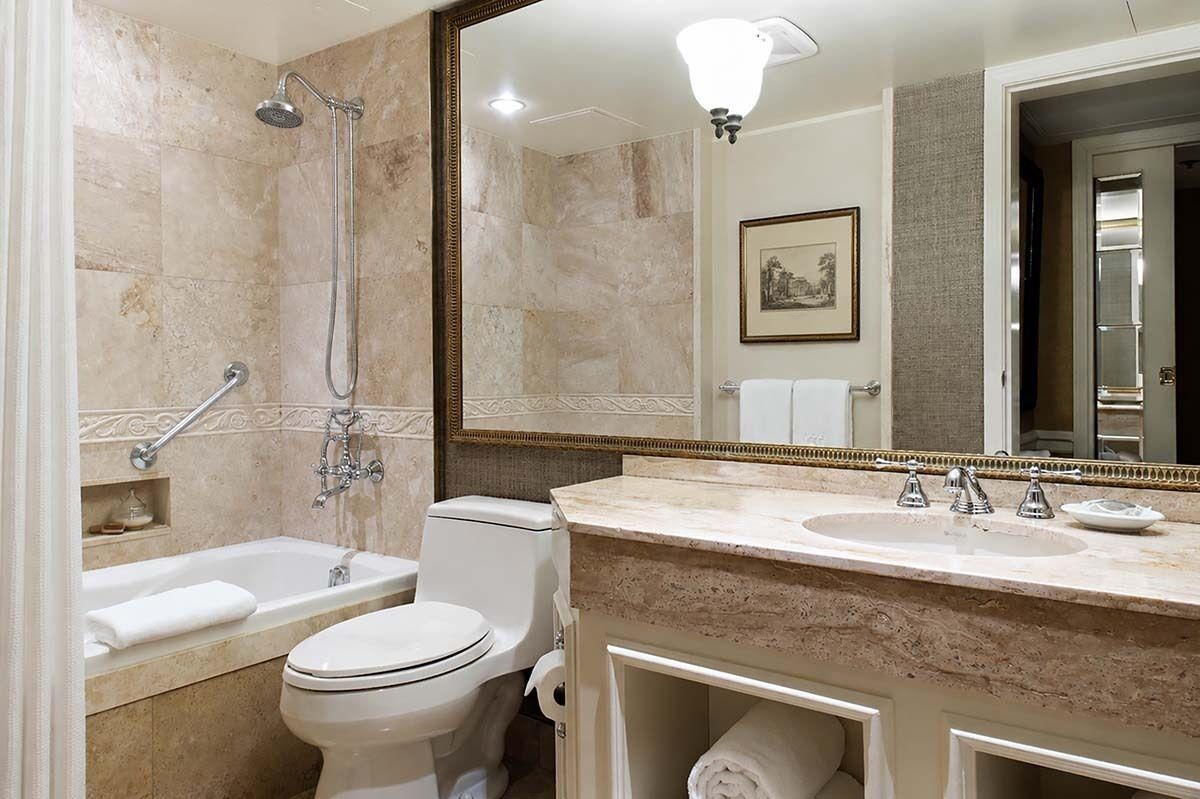 A bathroom with a bathtub, toilet, and sink, all in white.