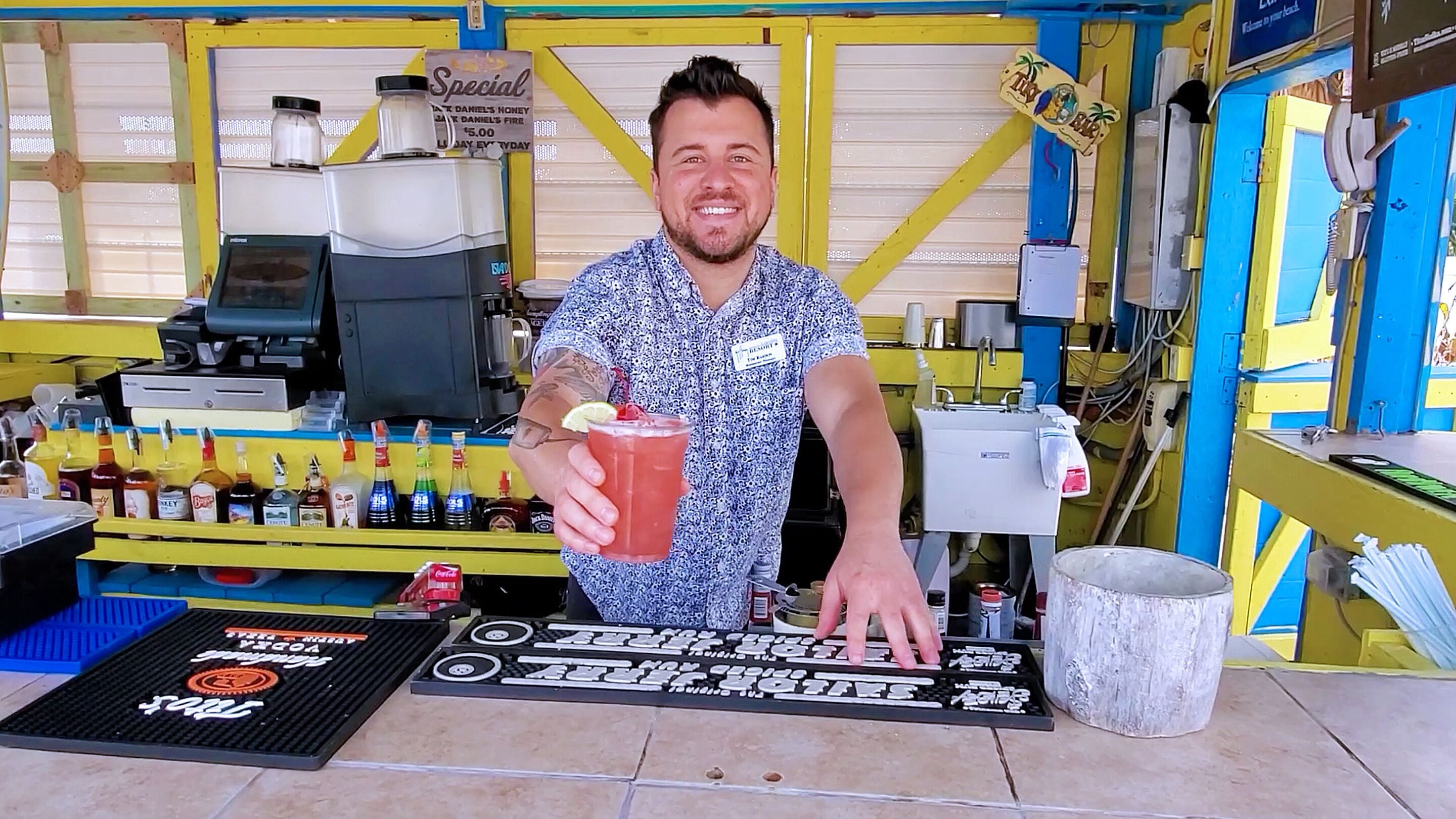 A bar area with a counter, various bottles, and a sign indicating a special offer.