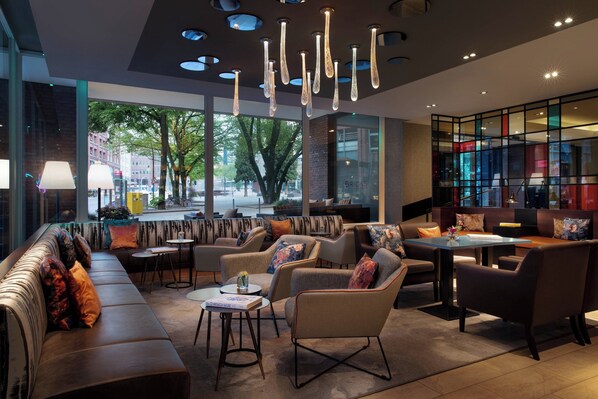 Relax in a spacious area with a variety of seating options, including a long bench and armchairs and sofas.