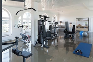 Stay fit and active in this well-equipped home gym with a pull-up bar, weight machines, and a bench.