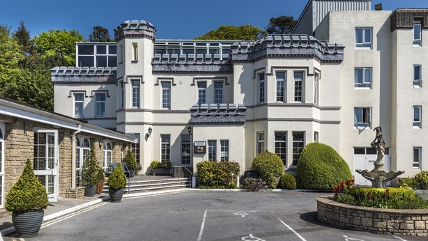 A large, historic building with a symmetrical facade, multiple windows, and a central entrance. - Stradey Park Hotel (Llanelli)