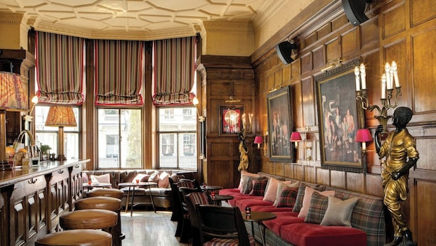 A traditional interior with a bar area, seating, and a statue.