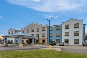 A hotel with a modern design, featuring a covered entrance and multiple floors.