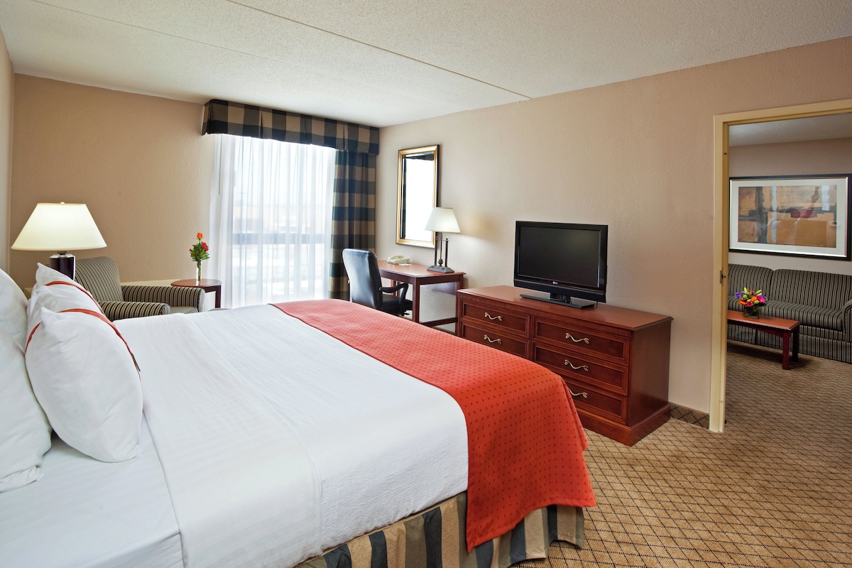 Premium bedding, desk, laptop workspace, blackout drapes