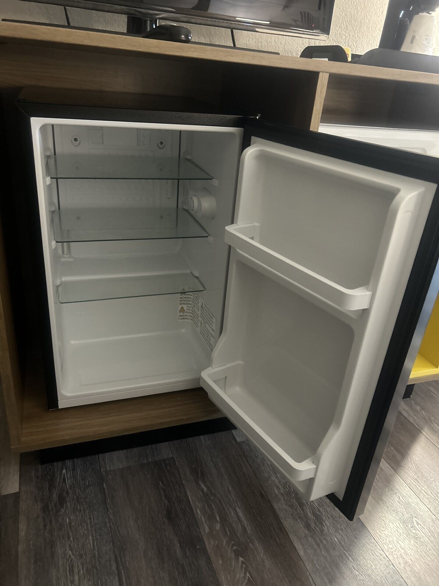 An open refrigerator with multiple shelves and a freezer compartment.
