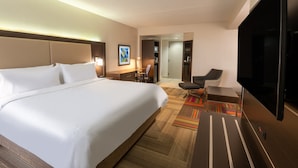 A hotel room with a large bed, a desk, a chair, a television, and a carpeted floor. - Holiday Inn Express Philadelphia NE - Bensalem by IHG (Bensalem)