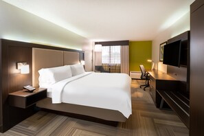 A hotel room with a large bed, a desk with a chair, a flat-screen TV, and a window with curtains. - Holiday Inn Express Philadelphia NE - Bensalem by IHG (Bensalem)