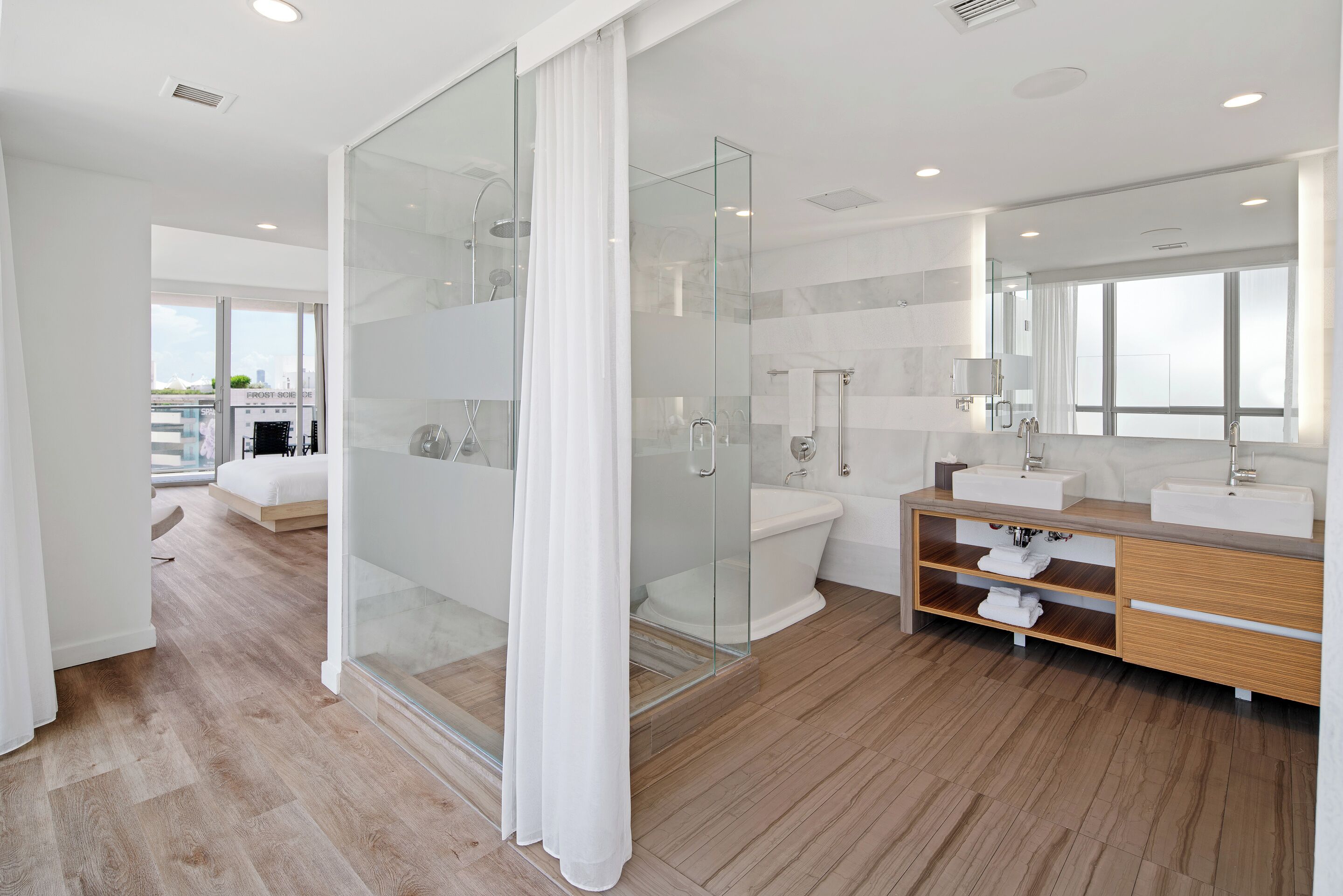 junior suite, 1 king bed, balcony, bay view | bathroom | designer toiletries, hair dryer, bathrobes, slippers