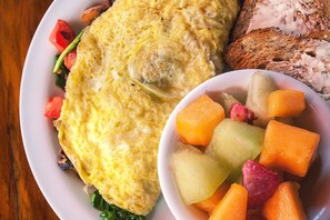 A plate with an omelet, toast, and a bowl of diced vegetables. - DoubleTree by Hilton Dallas - DFW Airport North (Irving)
