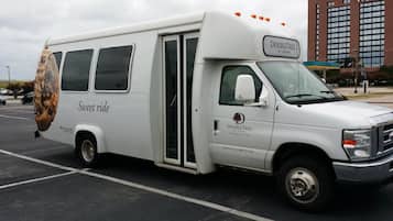 A white DoubleTree by Hilton bus parked in a lot.