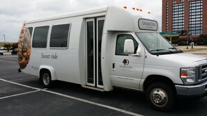 A white DoubleTree by Hilton bus parked in a lot. - DoubleTree by Hilton Dallas - DFW Airport North (Irving)