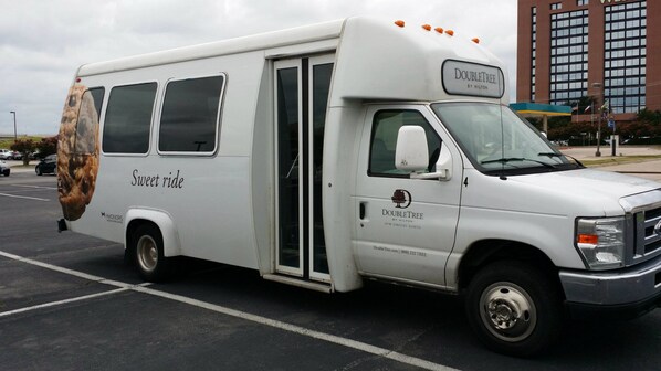A white DoubleTree by Hilton bus parked in a lot. - DoubleTree by Hilton Dallas - DFW Airport North (Irving)