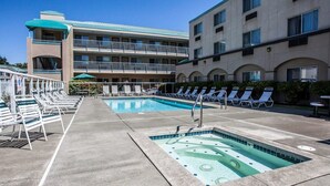 A hotel pool area with lounge chairs and a swimming pool.