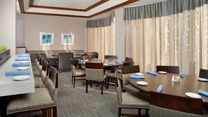 A conference room with a long table, multiple chairs, and a carpeted floor. - DoubleTree by Hilton Hotel Chicago Wood Dale - Elk Grove (Wood Dale)