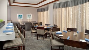 A conference room with a long table, multiple chairs, and a carpeted floor. - DoubleTree by Hilton Hotel Chicago Wood Dale - Elk Grove (Wood Dale)