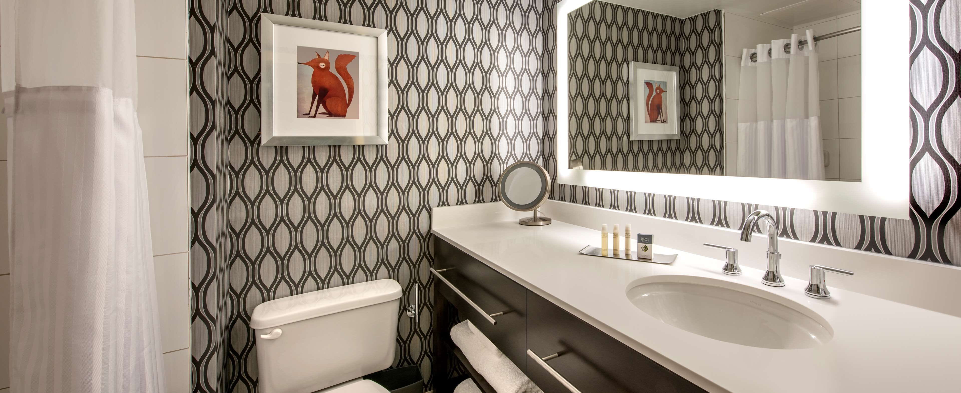 combined shower/bathtub, designer toiletries, hair dryer, bathrobes