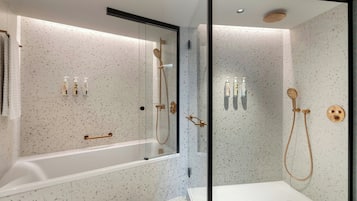 A modern bathroom with a freestanding bathtub, a glass-enclosed shower, and a separate shower area.