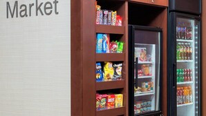 A vending machine and snack shelves in a store named 'The Corner Market'. - Fairfield Inn & Suites by Marriott Temple Belton (Temple)