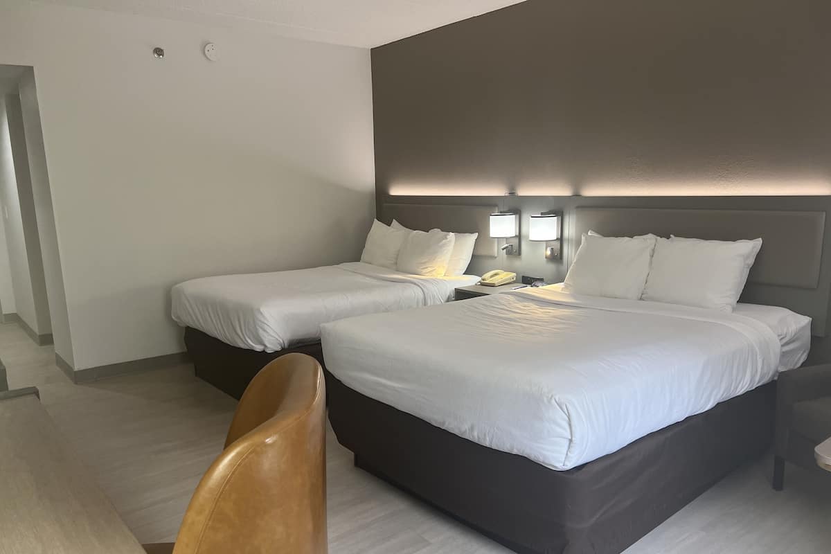 Hypo-allergenic bedding, desk, laptop workspace, blackout drapes