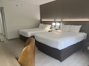 Hypo-allergenic bedding, desk, laptop workspace, blackout drapes