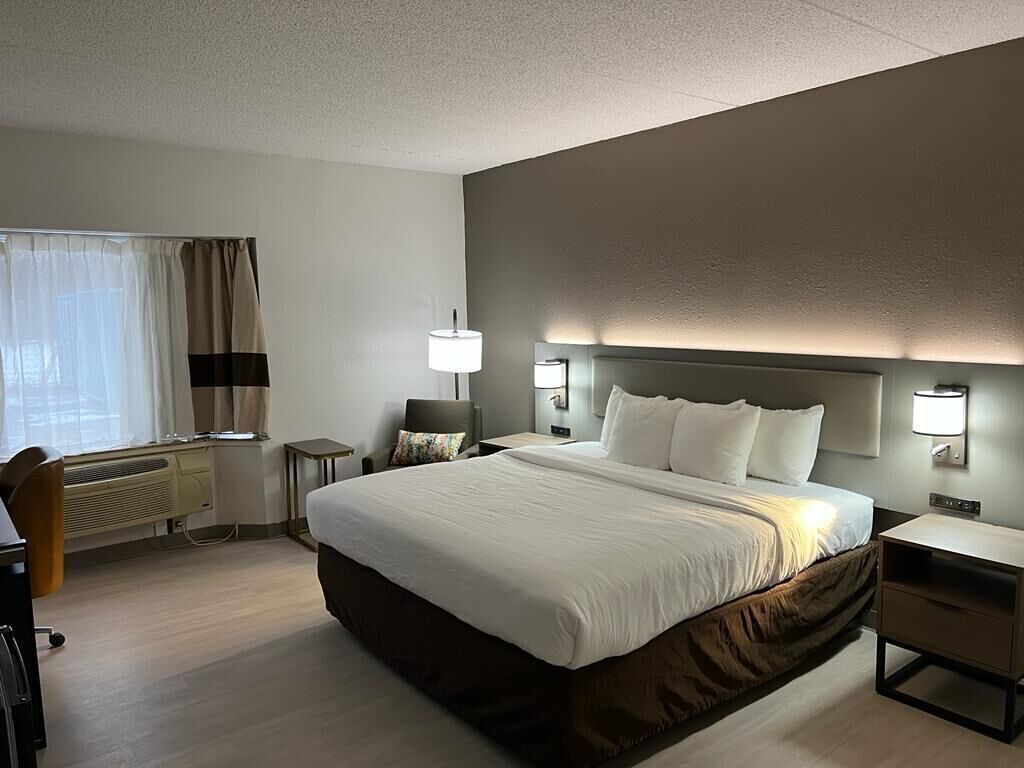 Hypo-allergenic bedding, desk, laptop workspace, blackout drapes