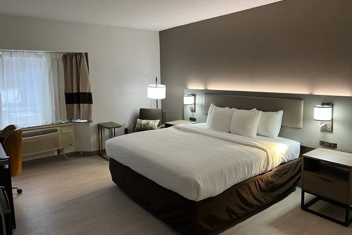 Hypo-allergenic bedding, desk, laptop workspace, blackout drapes