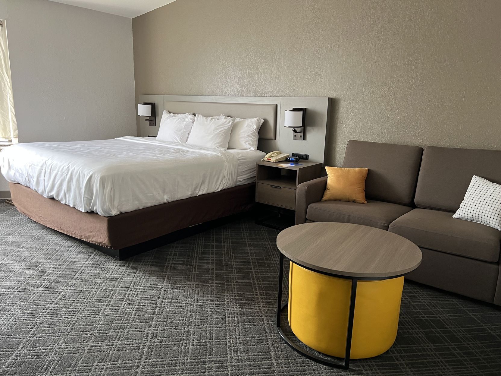 Hypo-allergenic bedding, desk, laptop workspace, blackout drapes