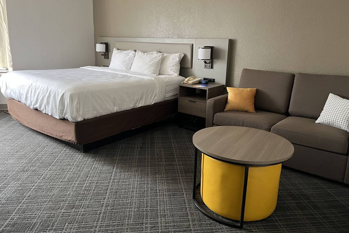Hypo-allergenic bedding, desk, laptop workspace, blackout drapes