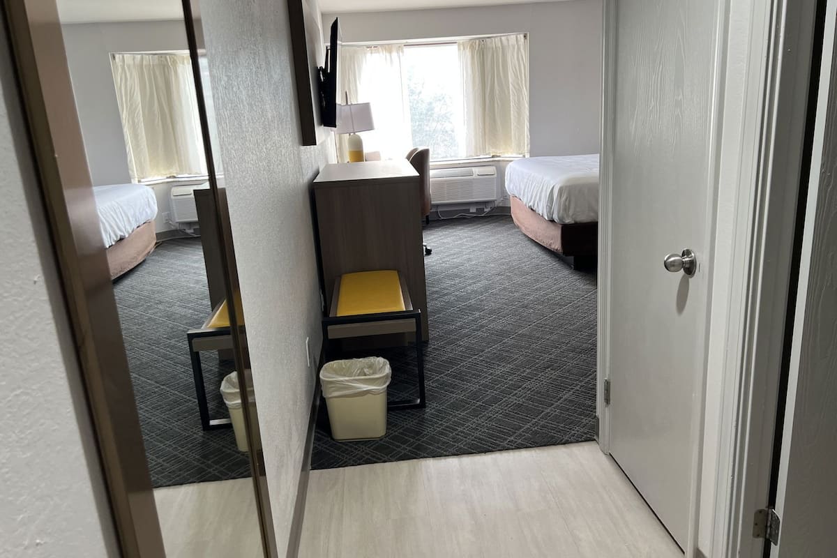 Hypo-allergenic bedding, desk, laptop workspace, blackout drapes
