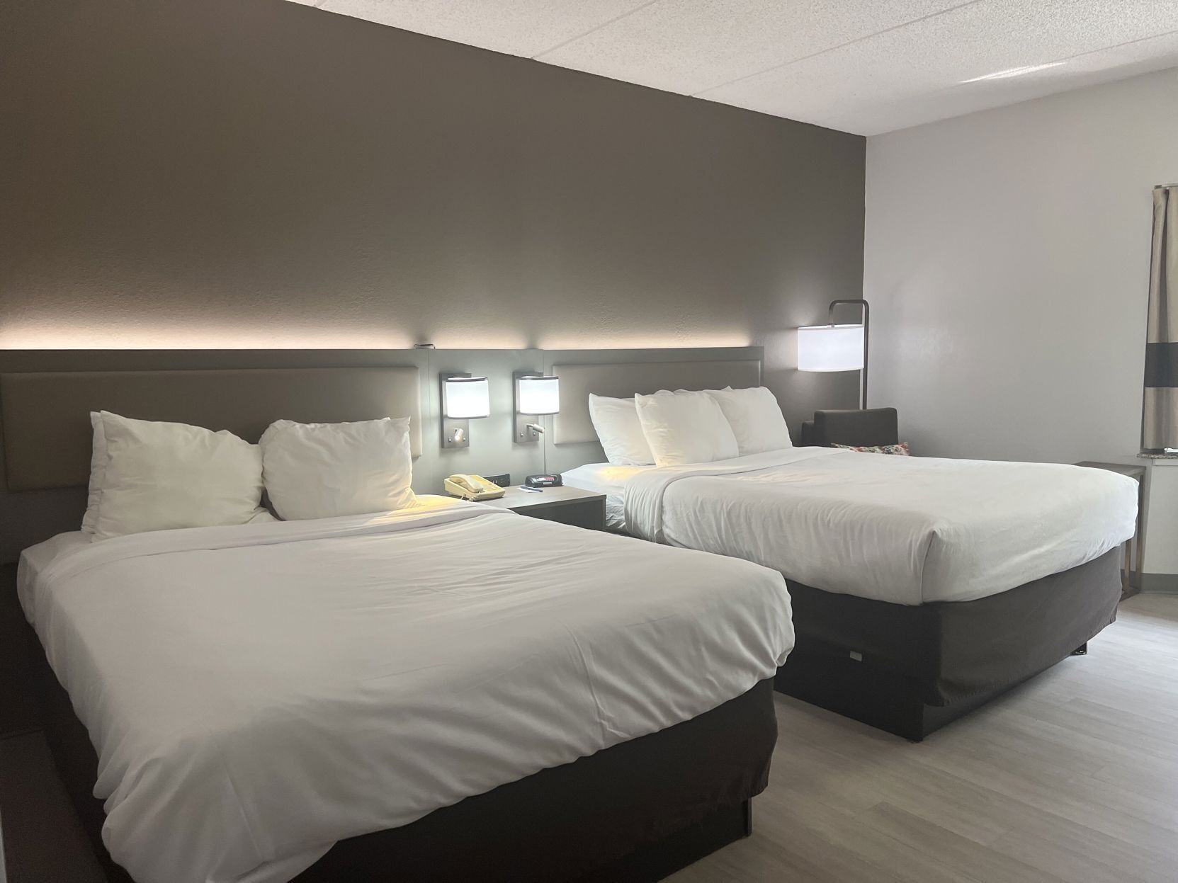Hypo-allergenic bedding, desk, laptop workspace, blackout drapes